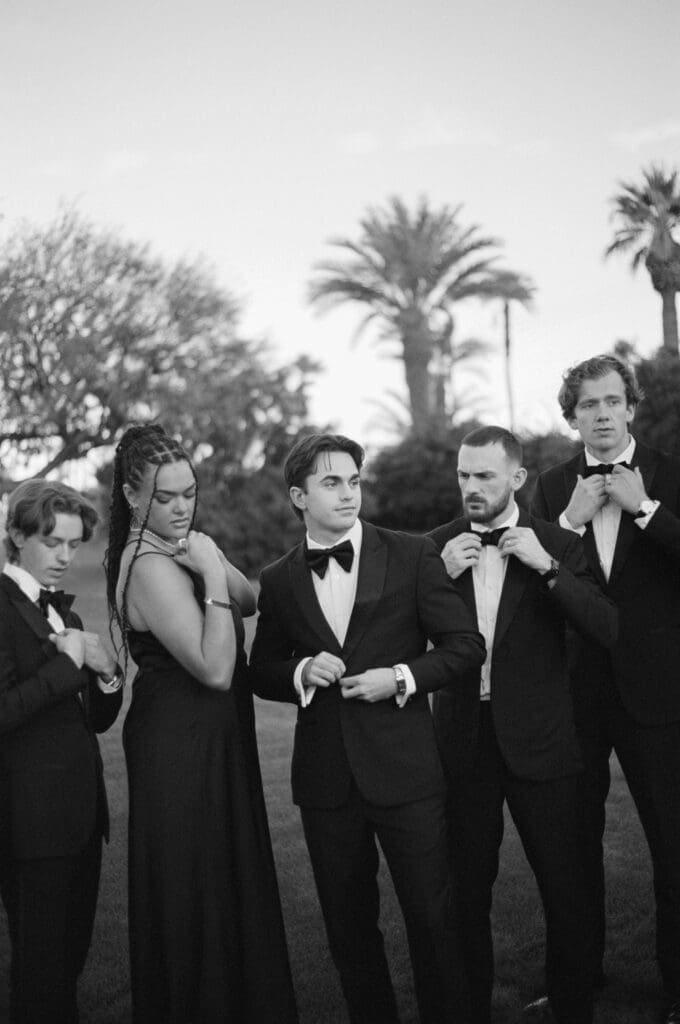 Black and white candid of the groom's wedding party 