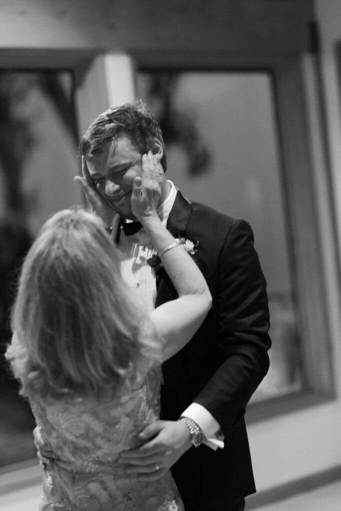 Black and white photo of the groom sharing a dance with his mother.