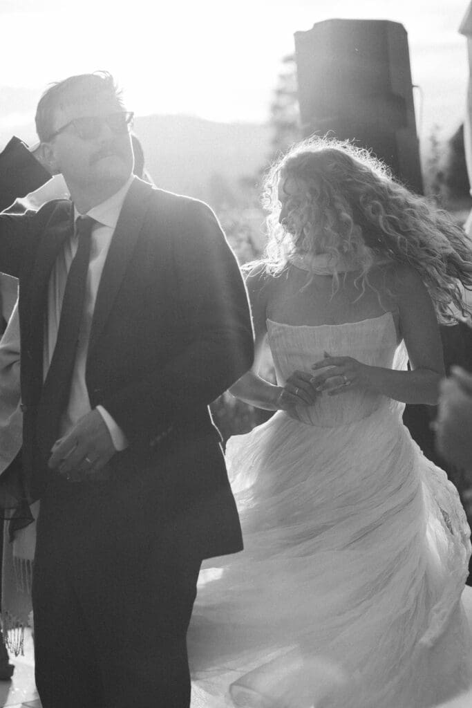 Black and white candid of the bride and groom dancing together during their reception.